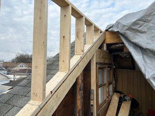 a wooden structure with a ladder by Plumb Tree Builders