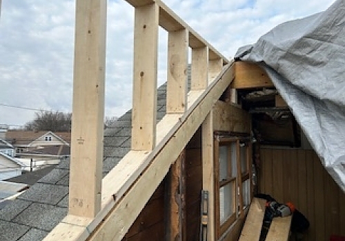 a wooden structure with a ladder by Plumb Tree Builders