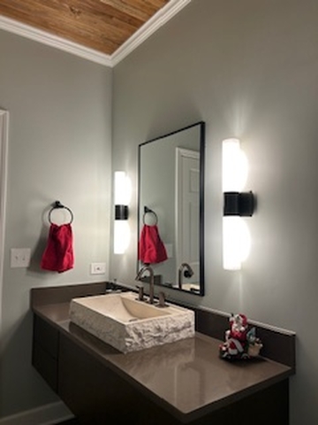 a bathroom renovation in Hinsdale featuring a mirror, sink, and towel rack