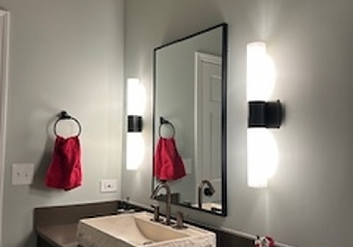 a bathroom renovation in Hinsdale featuring a mirror, sink, and towel rack