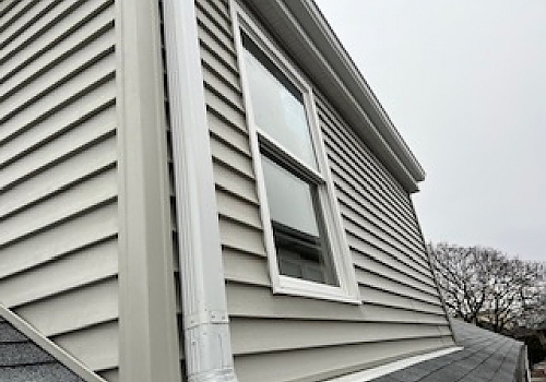 a newly installed window with white trim and black detailing