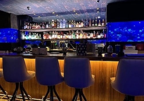 bar area with custom-built counter by Plumb Tree Builders in Park Ridge