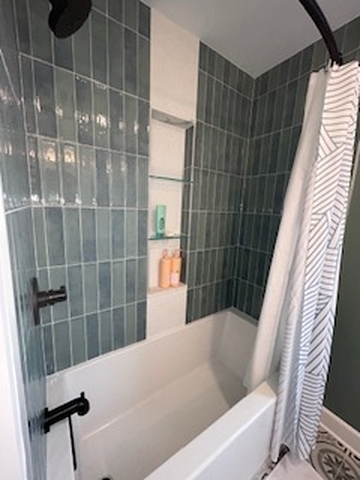 a modernized bathroom with a shower, sink, and tub in Hinsdale