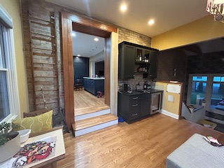 new kitchen with stove, sink, and refrigerator by Plumb Tree Builders